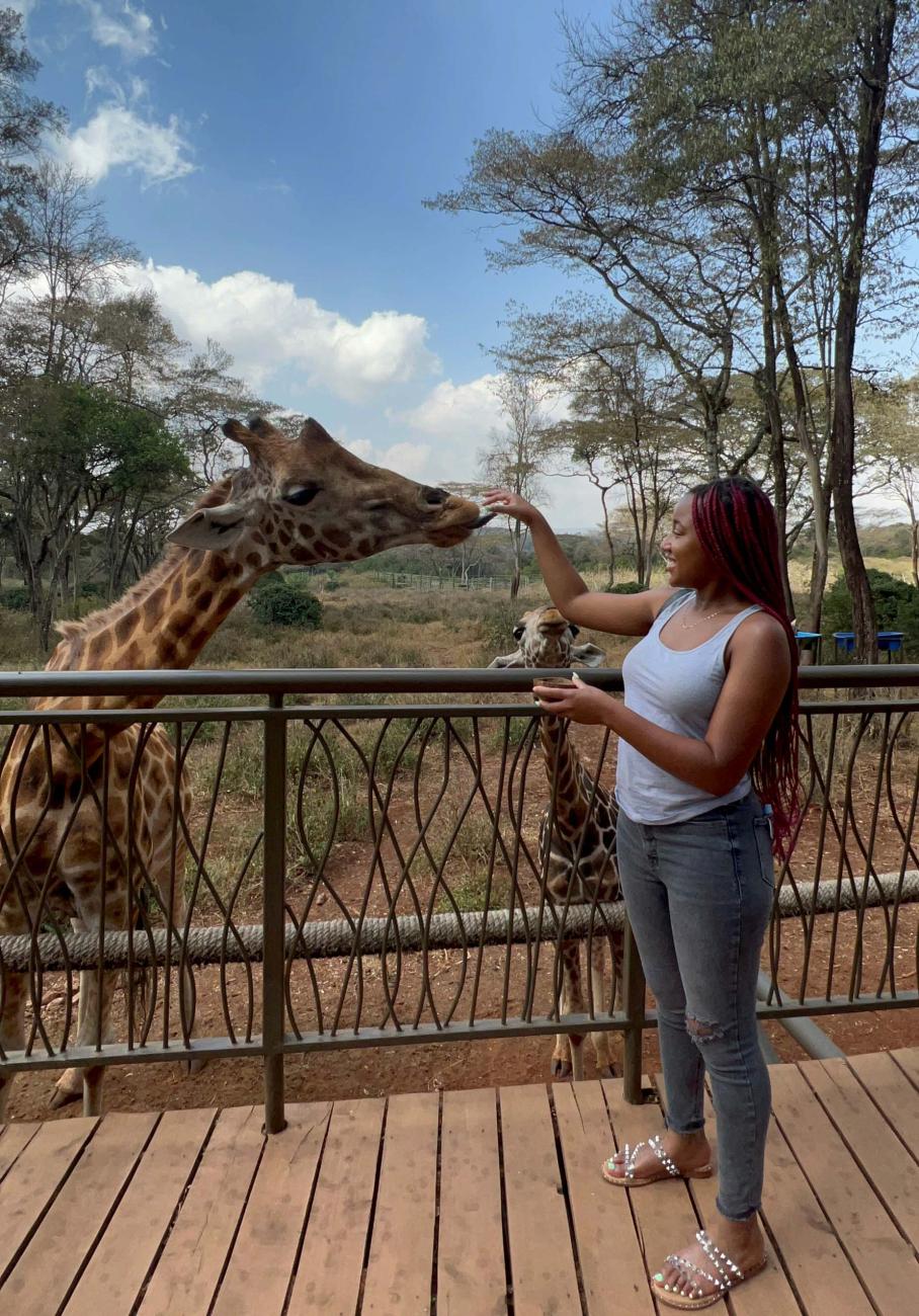 Kiya Henderson '23 interacting with giraffes.