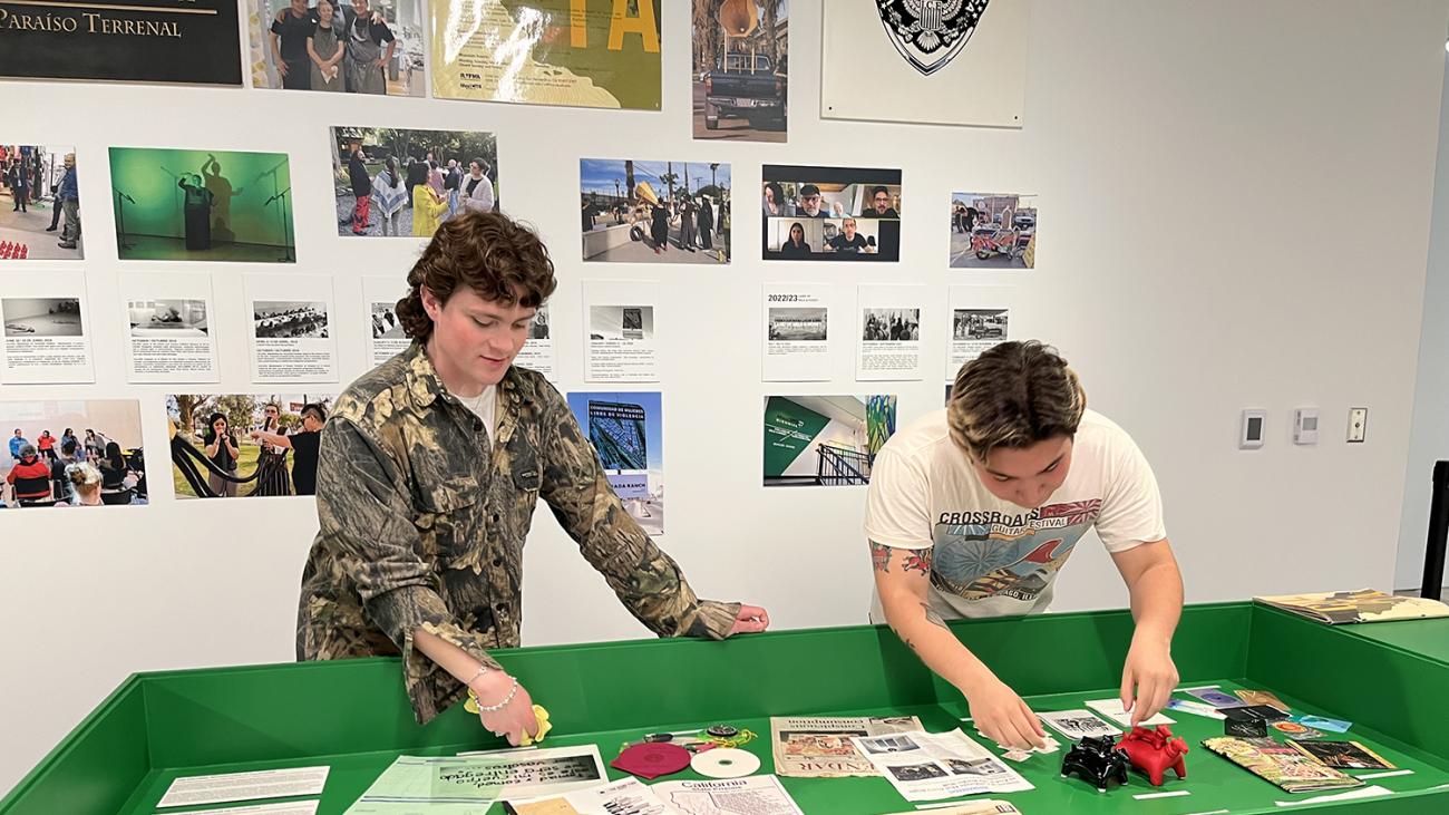 Samuel White and Daniel Velazquez installing an exhibit at the Cheech