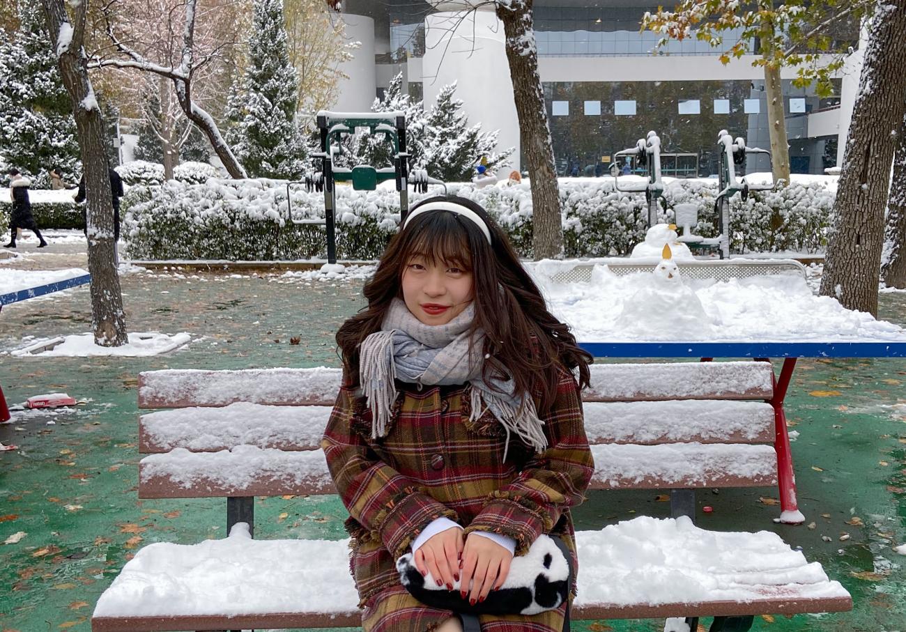 Chinese Language Resident sitting on a bench