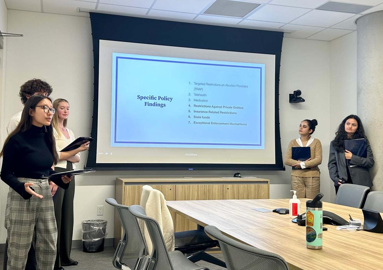 Students giving PowerPoint presentation in conference room