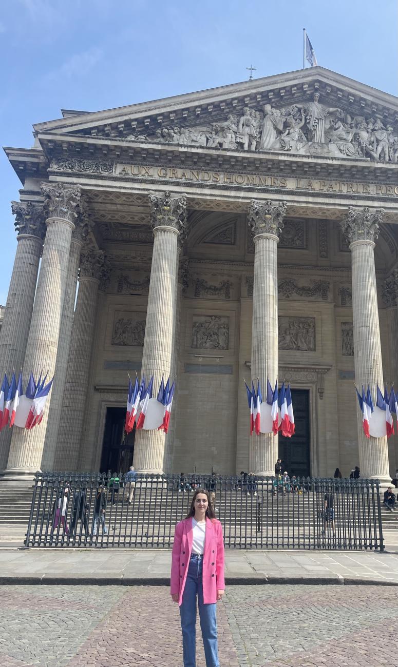 French Language Resident standing in front of a building