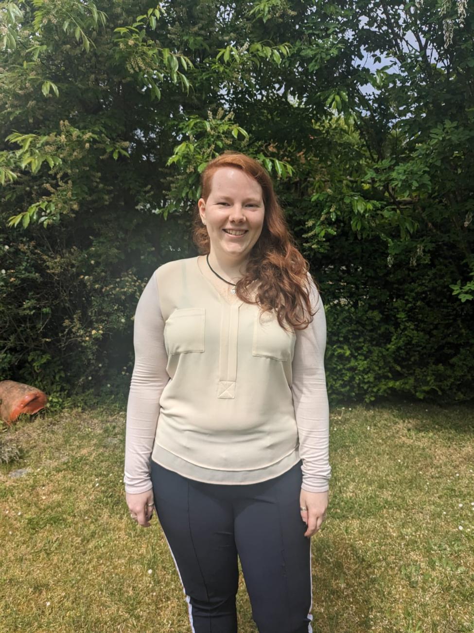 German Language resident standing in grassy area