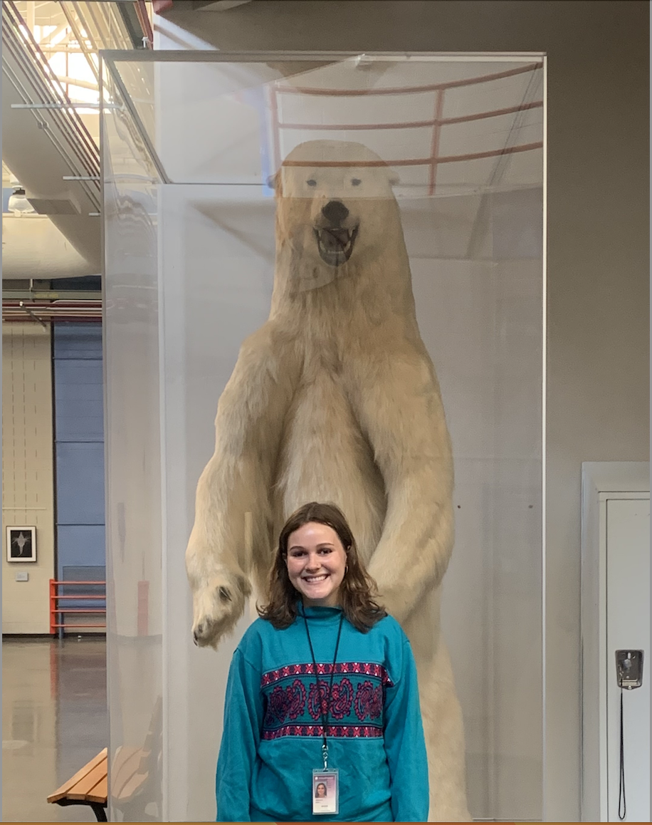 Eva Nichols at the Smithsonian posing in front of stuffed polar bear