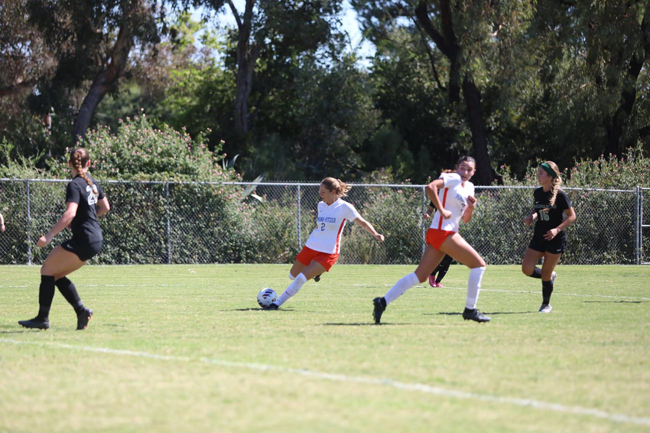 Sagehen midfielder Eli Prosnitz '25 kicks the soccer ball.