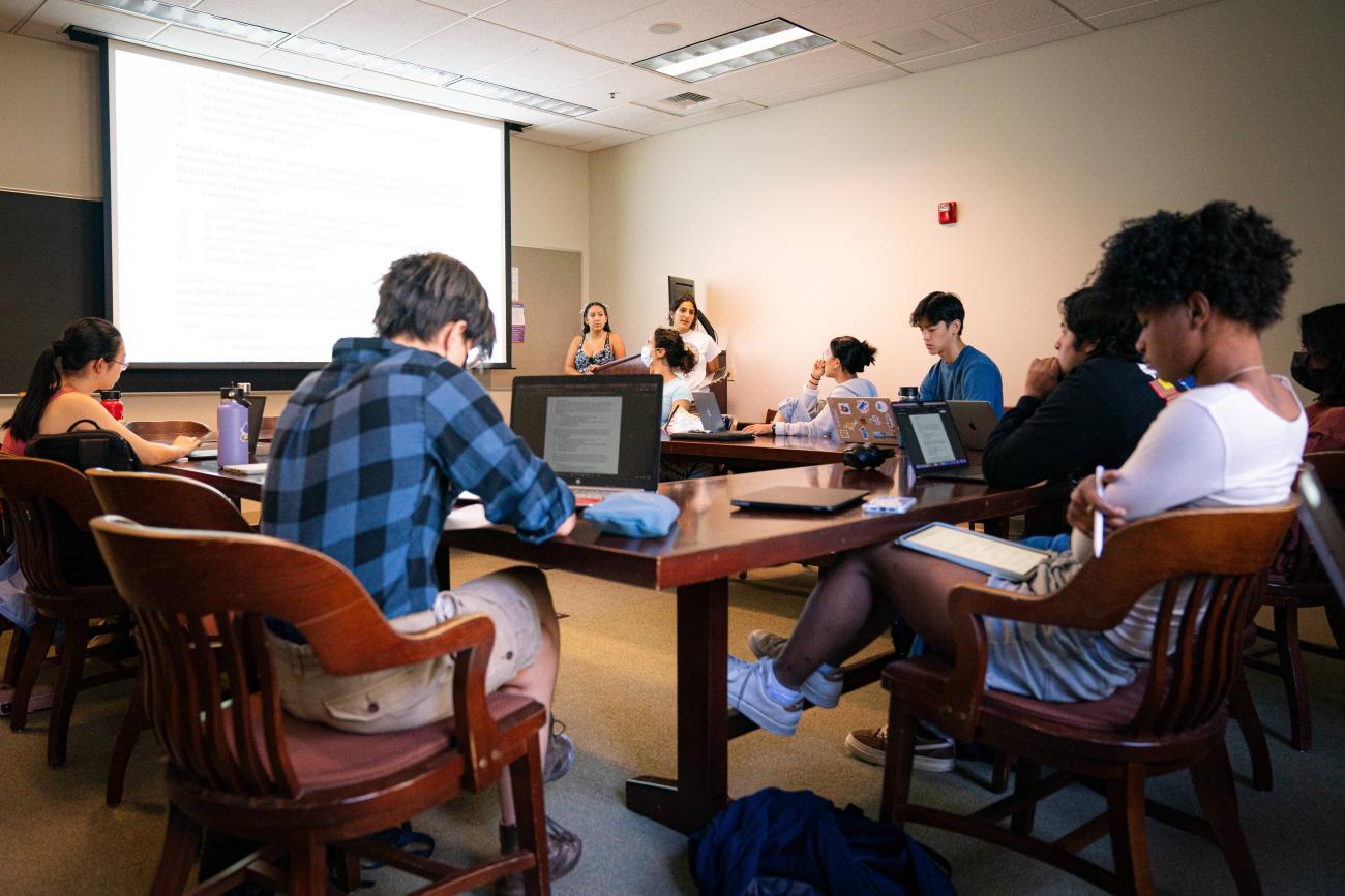 Students listen to a presentation during class.