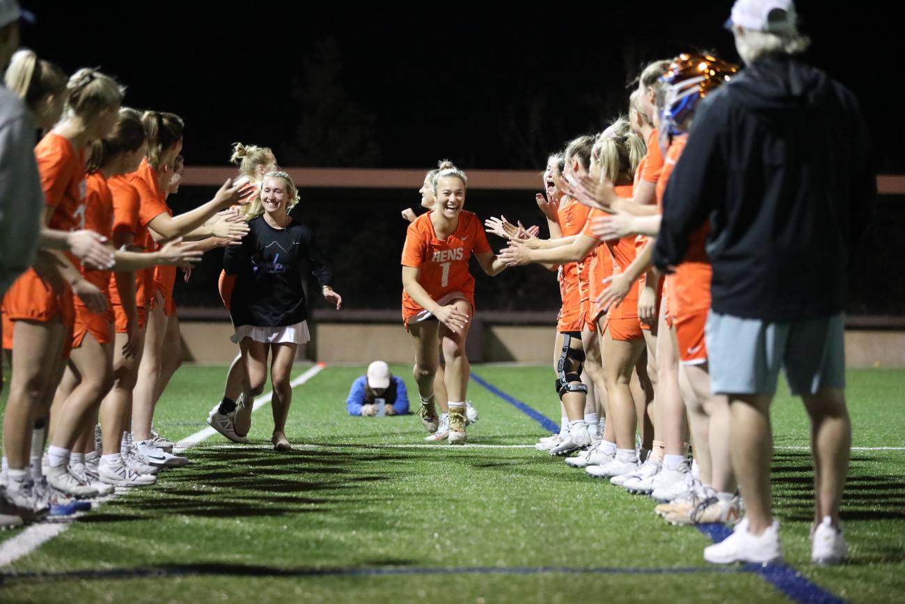 Chloe Boudreau '24 high fives her teammates before a game