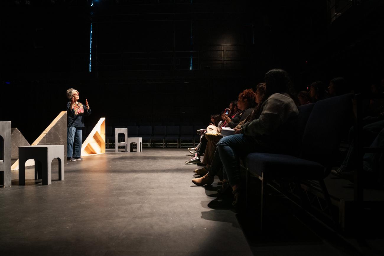 Rose Portillo '75 stands on stage before a rehearsal.
