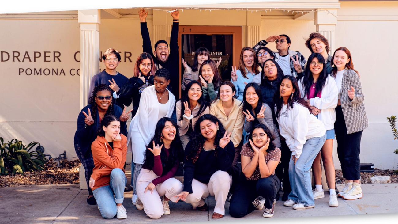 A photo of students gathered with happy faces in front of the Draper Center building.