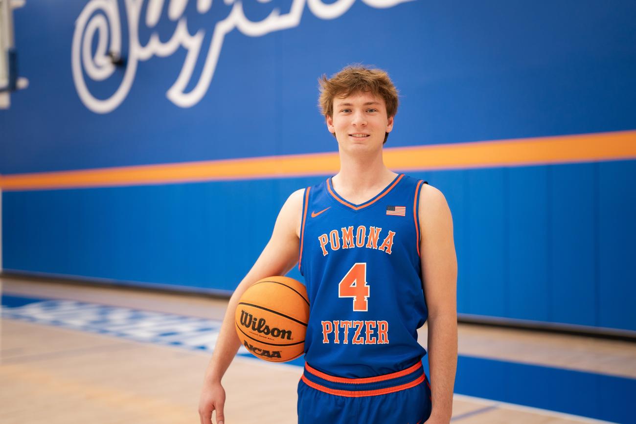 Connor Fitzgerald standing on a basketball court holding a basketball