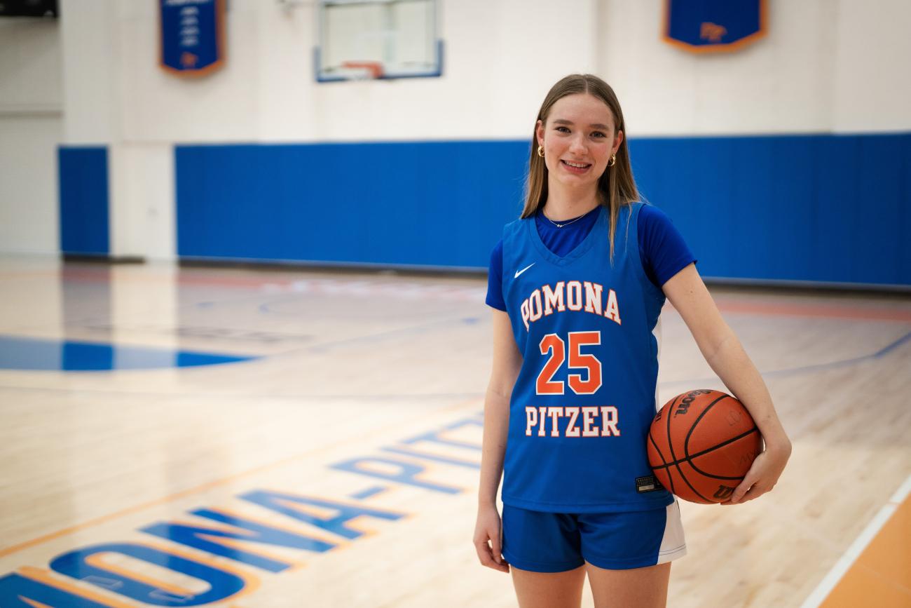 Elsa Cottrell holds a basketball inside a gym