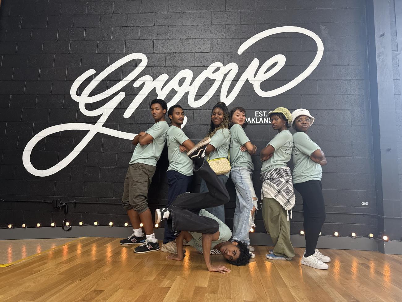 Students pose inside a dance studio