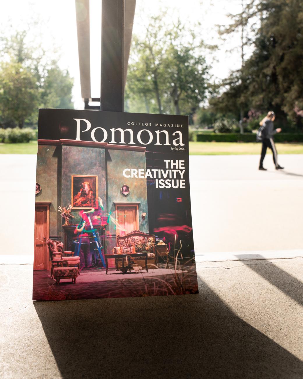 Magazine leaving against a pole with person in background walking