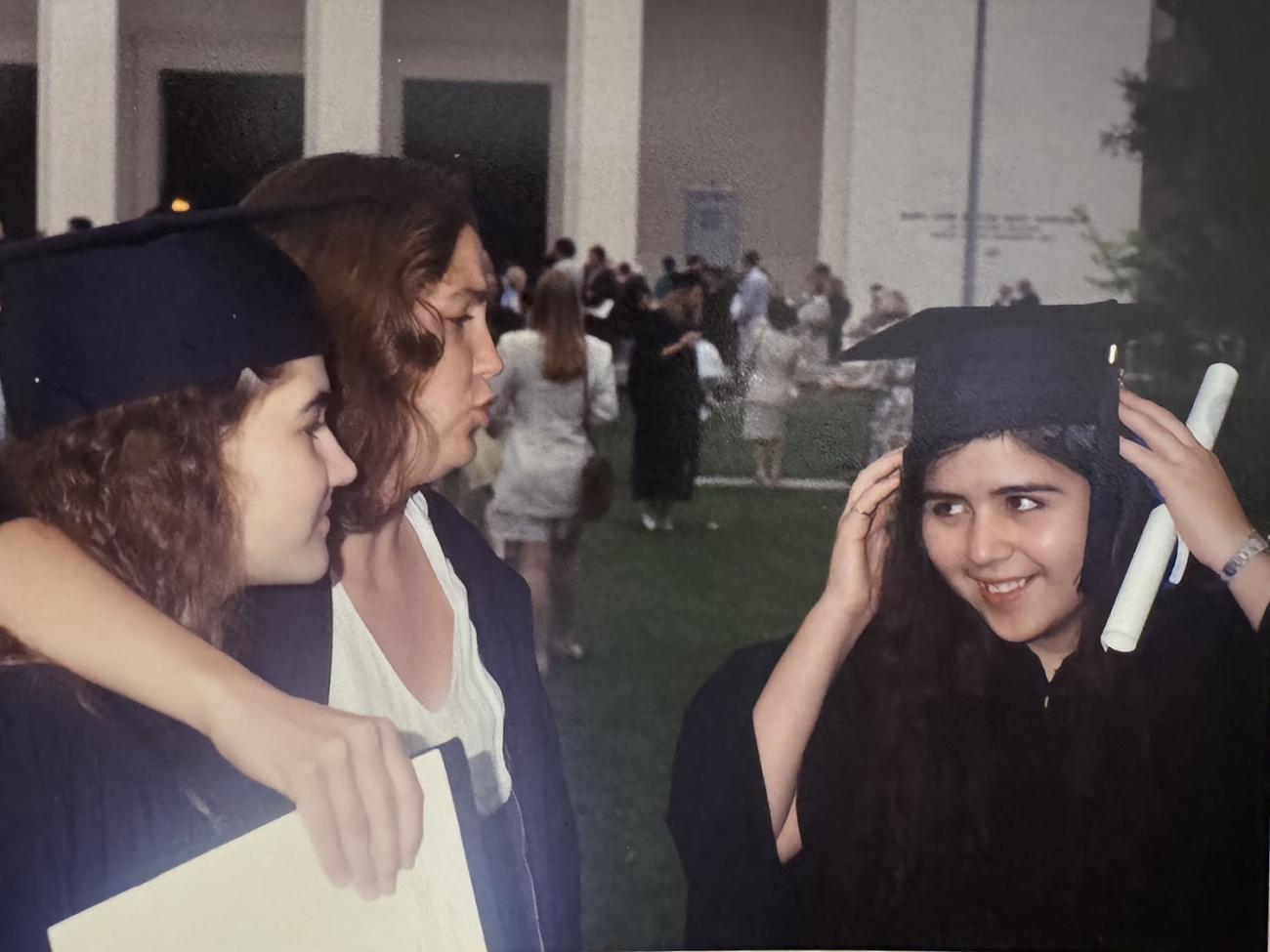Jimenez at her college graduation with other graduates in cap and gowns
