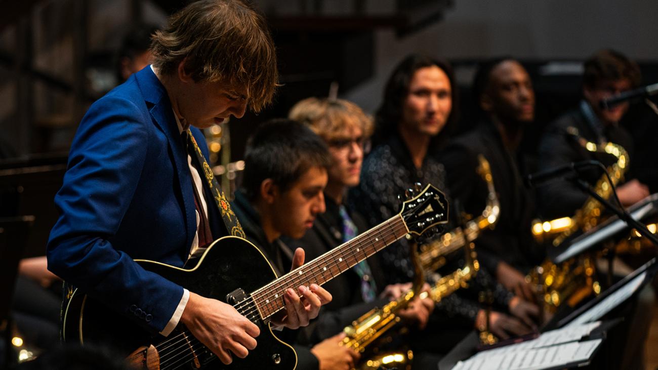 Student solos on guitar in Pomona College Jazz Ensemble
