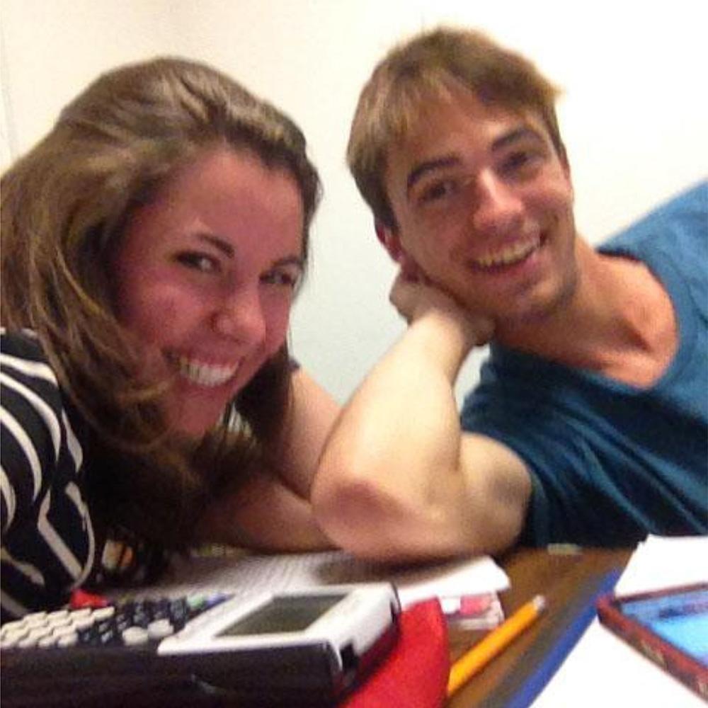 Photo of Ashley Simons Hathaway and her husband Adam Hathaway when students studying for a math exam at Pomona College.