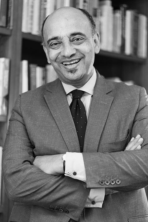 Man wearing suit with arms folded