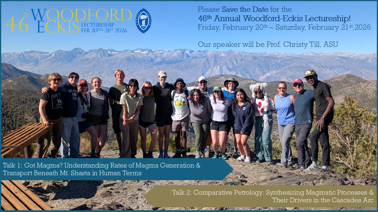 A group of students stand in front of a range of mountains