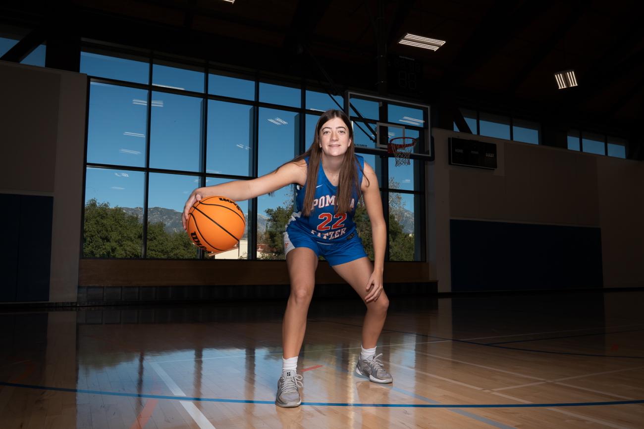 A woman dribbles a basketball
