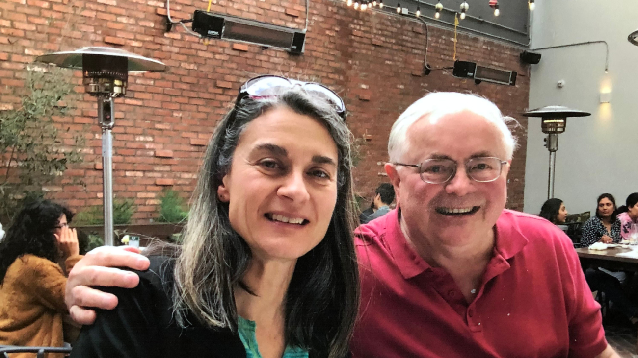 Professor Gorse and Julie Nicoletta pose together at a restaurant 