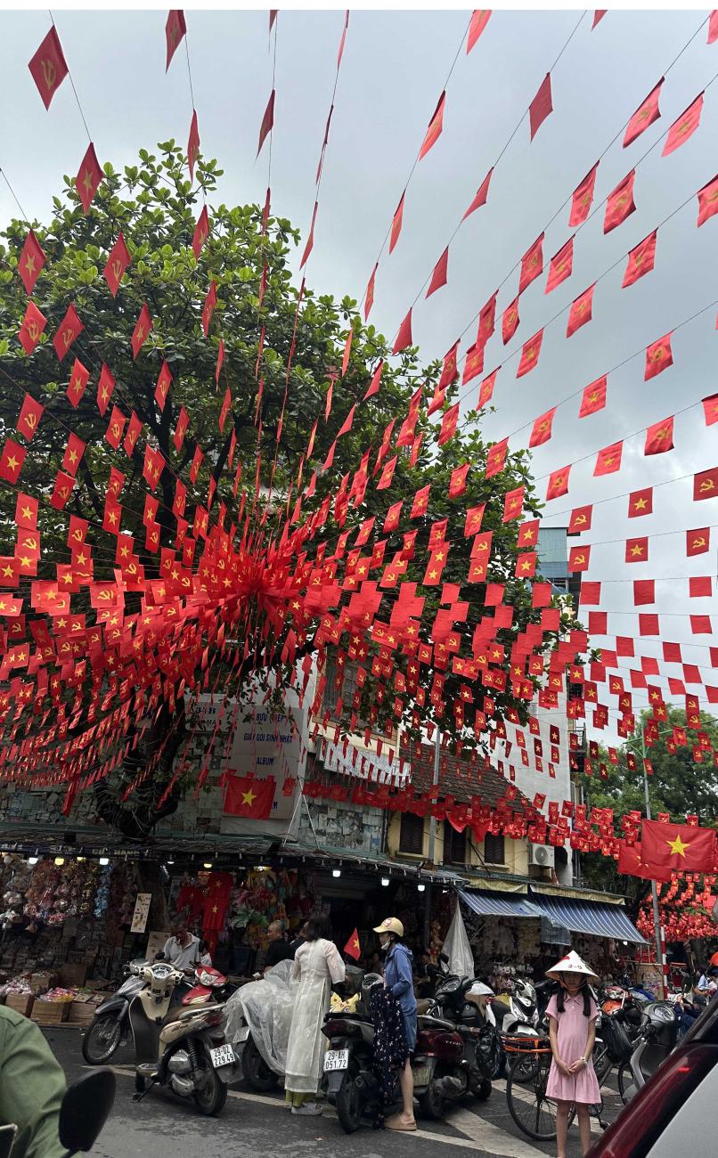 Red flags over a city street in Hanoi.