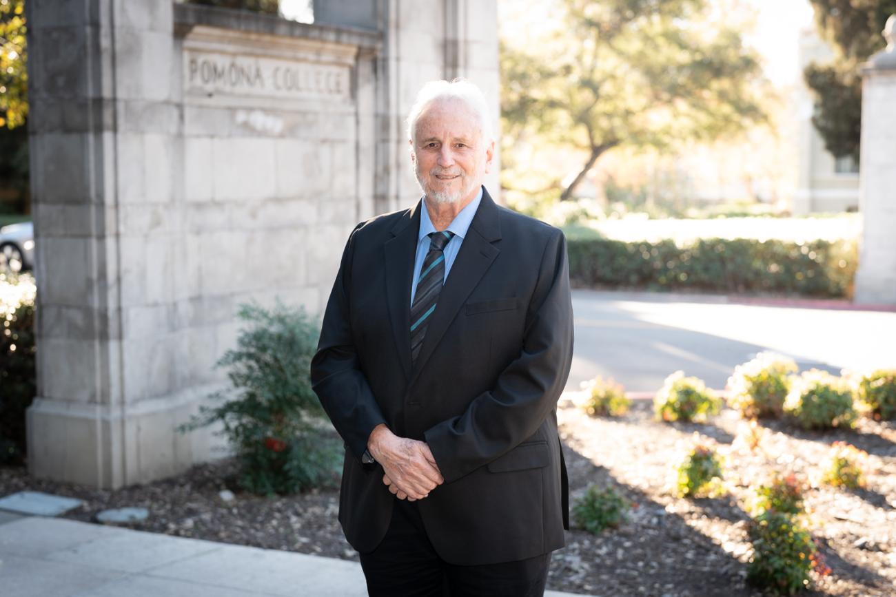 Prof. Miguel Tinker Salas standing by the Pomona College gates
