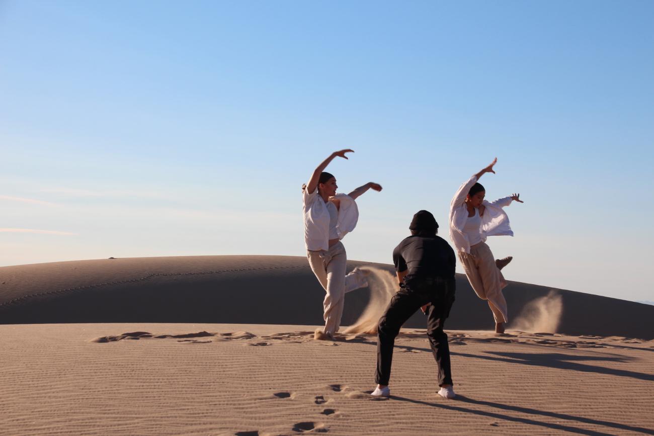 Two people dancing in the desert