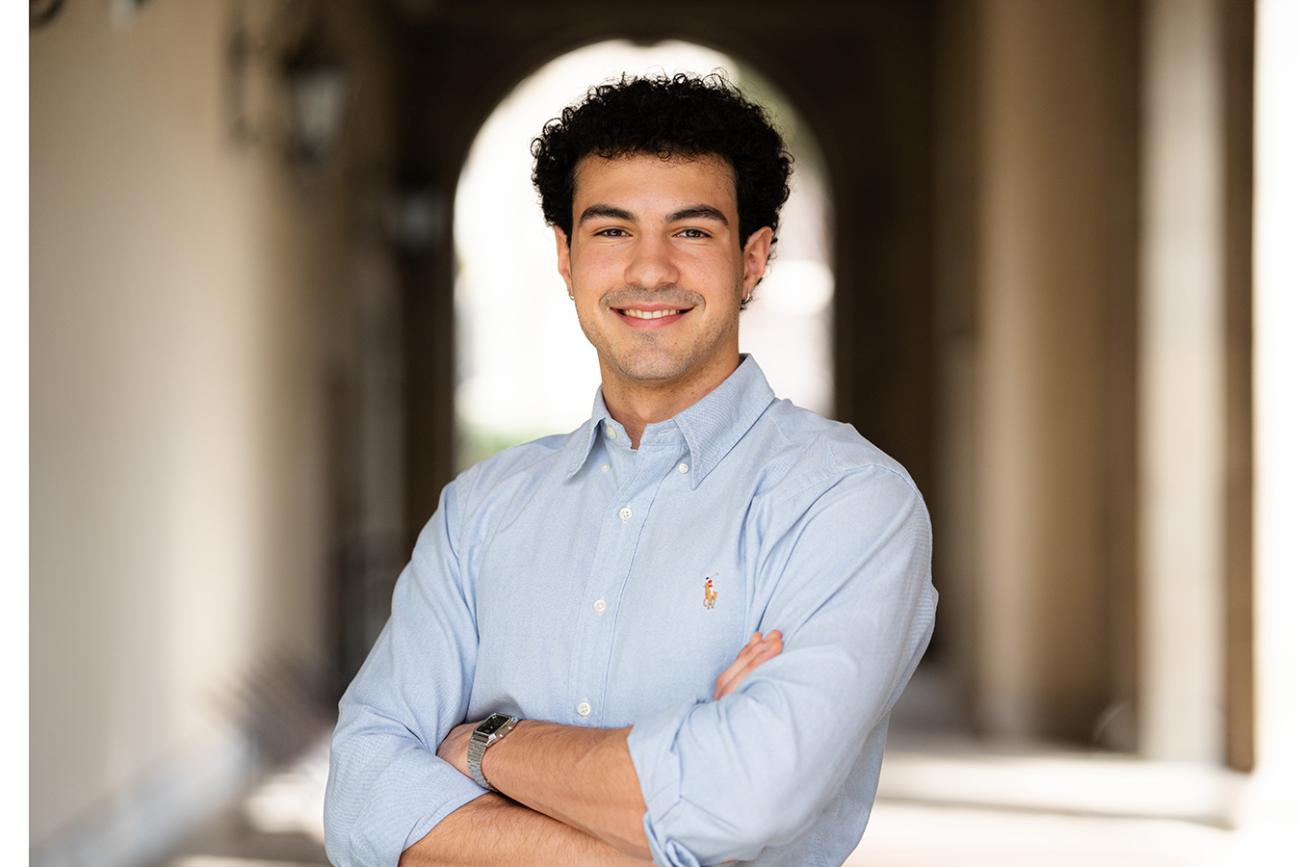 Sebastian KInzie '26 standing near an archway.