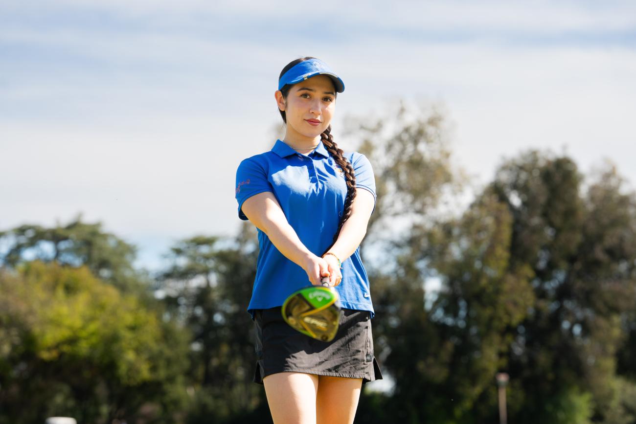 Rachel LeMay holds a golf club