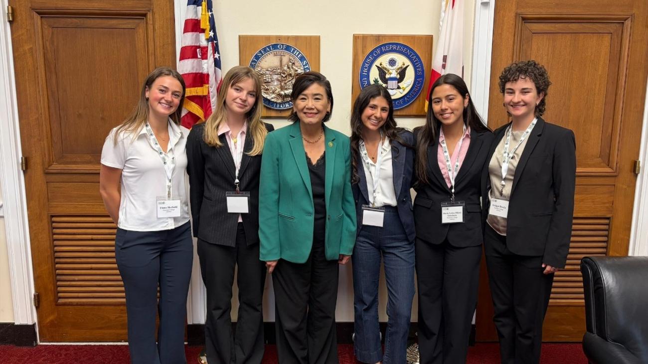 Five Pomona students stand with Representative Judy Chu outside Chu's office