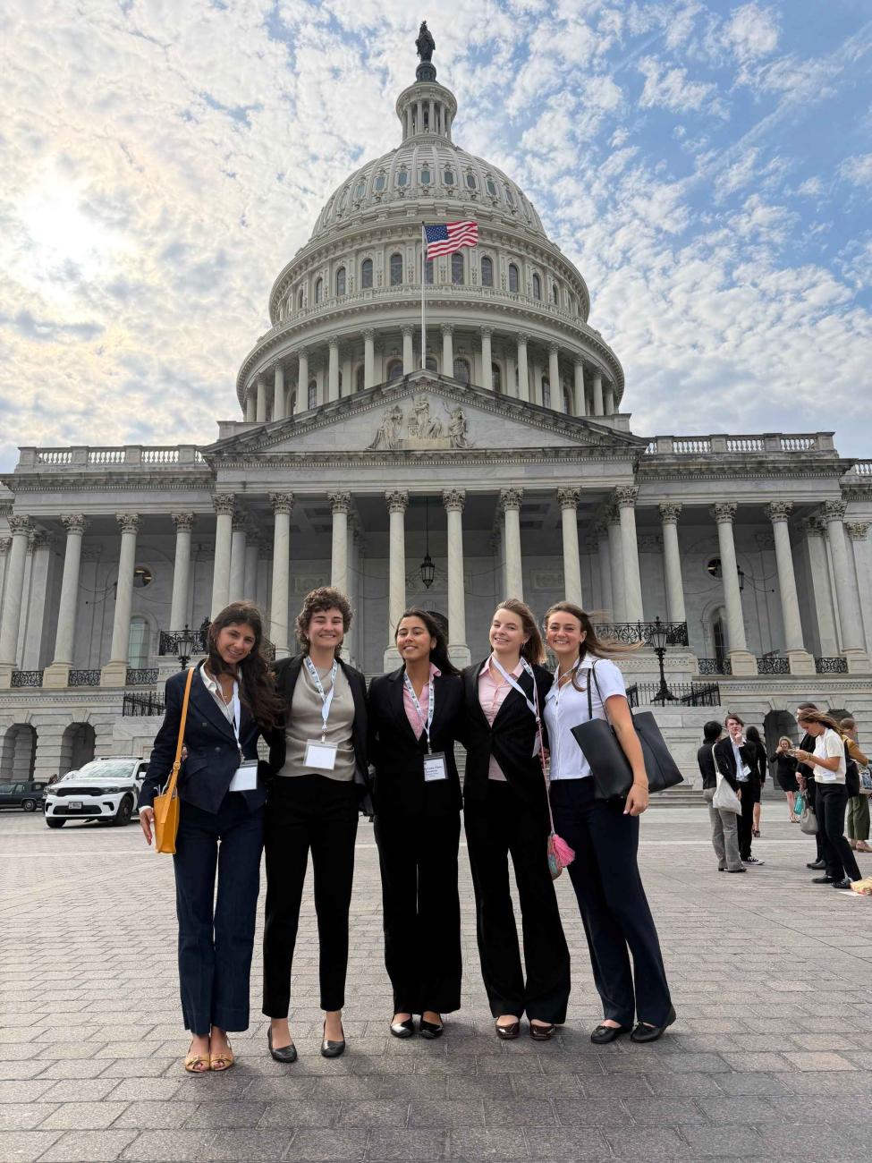 Five Pomona students stand in front of the U.S. Capitol building