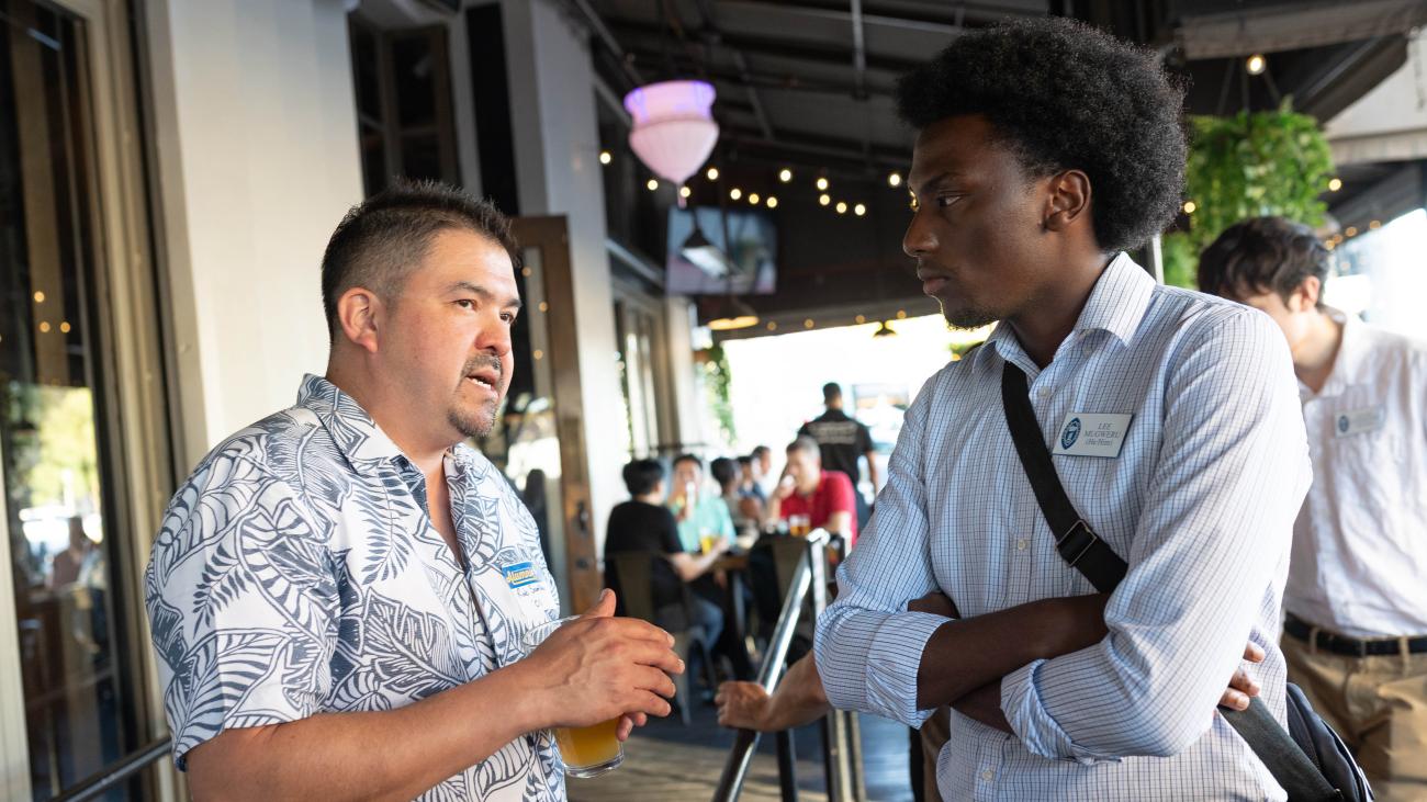 Lee Mugweru '28 talks to an alumnus.