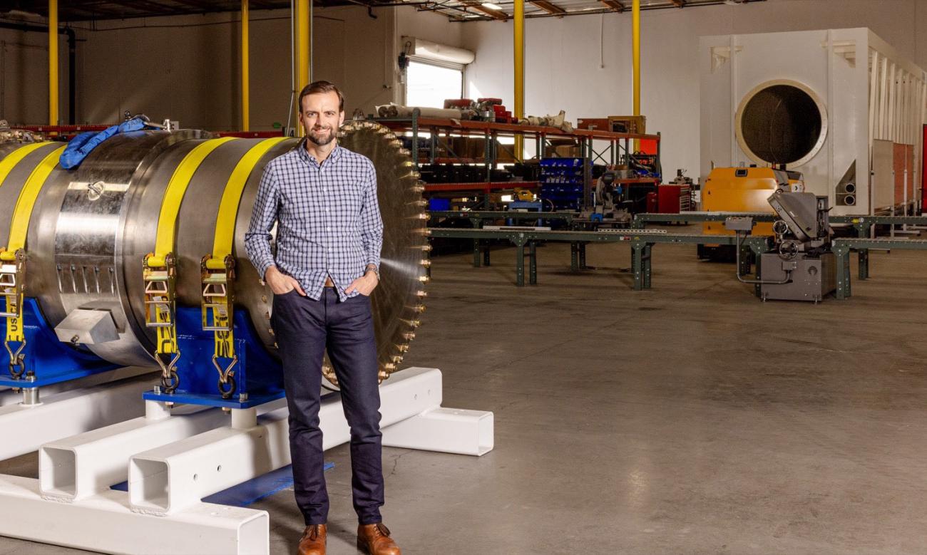Alex Zylstra poses for a photo in a warehouse 
