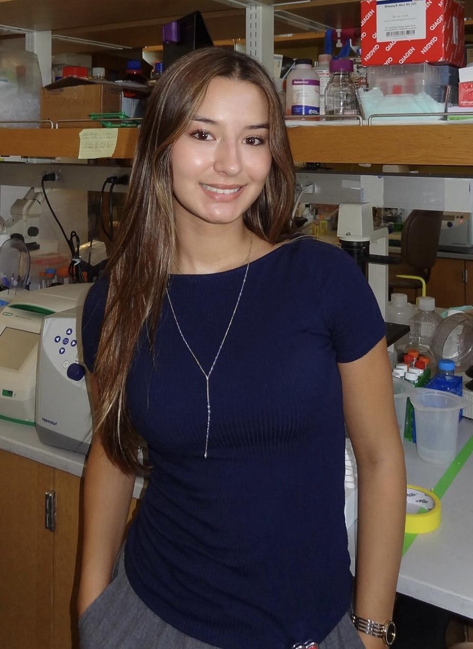 Ella Lee-Guest stands in UCSD lab.