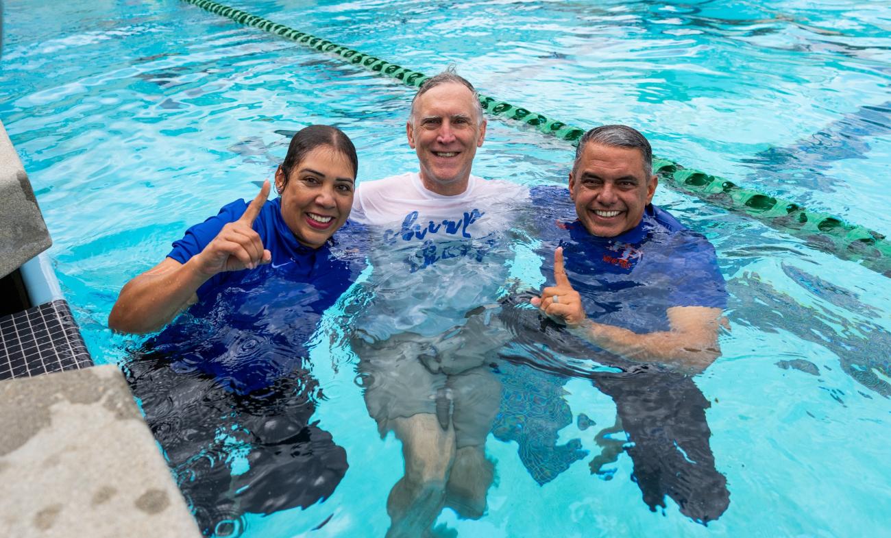 Three adults in a pool