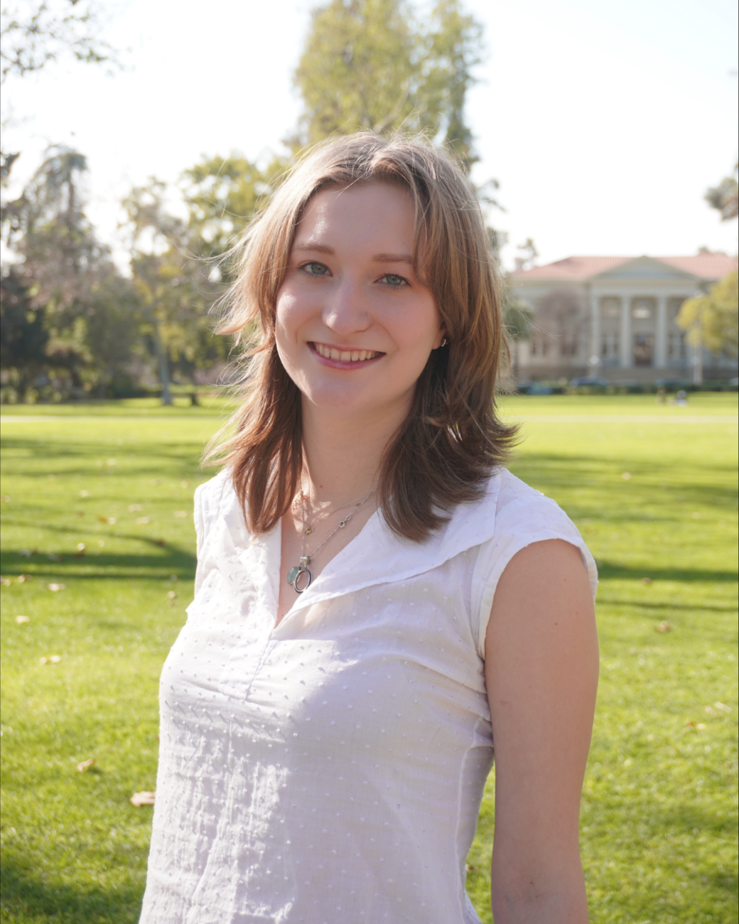 Student poses for photo smiling at Marston Quad. 
