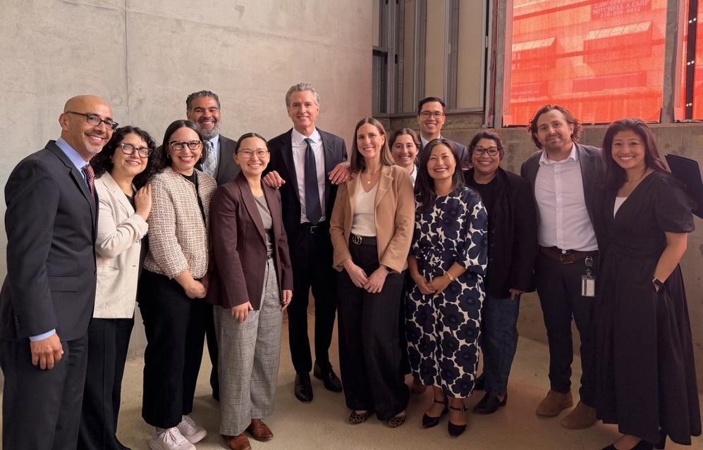 A group of people with Governor Gavin Newsom