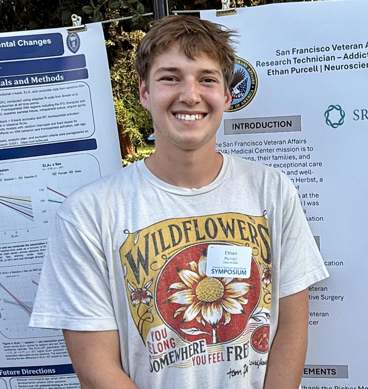 Ethan Purcell stands by his SURP poster on Stover Walk.
