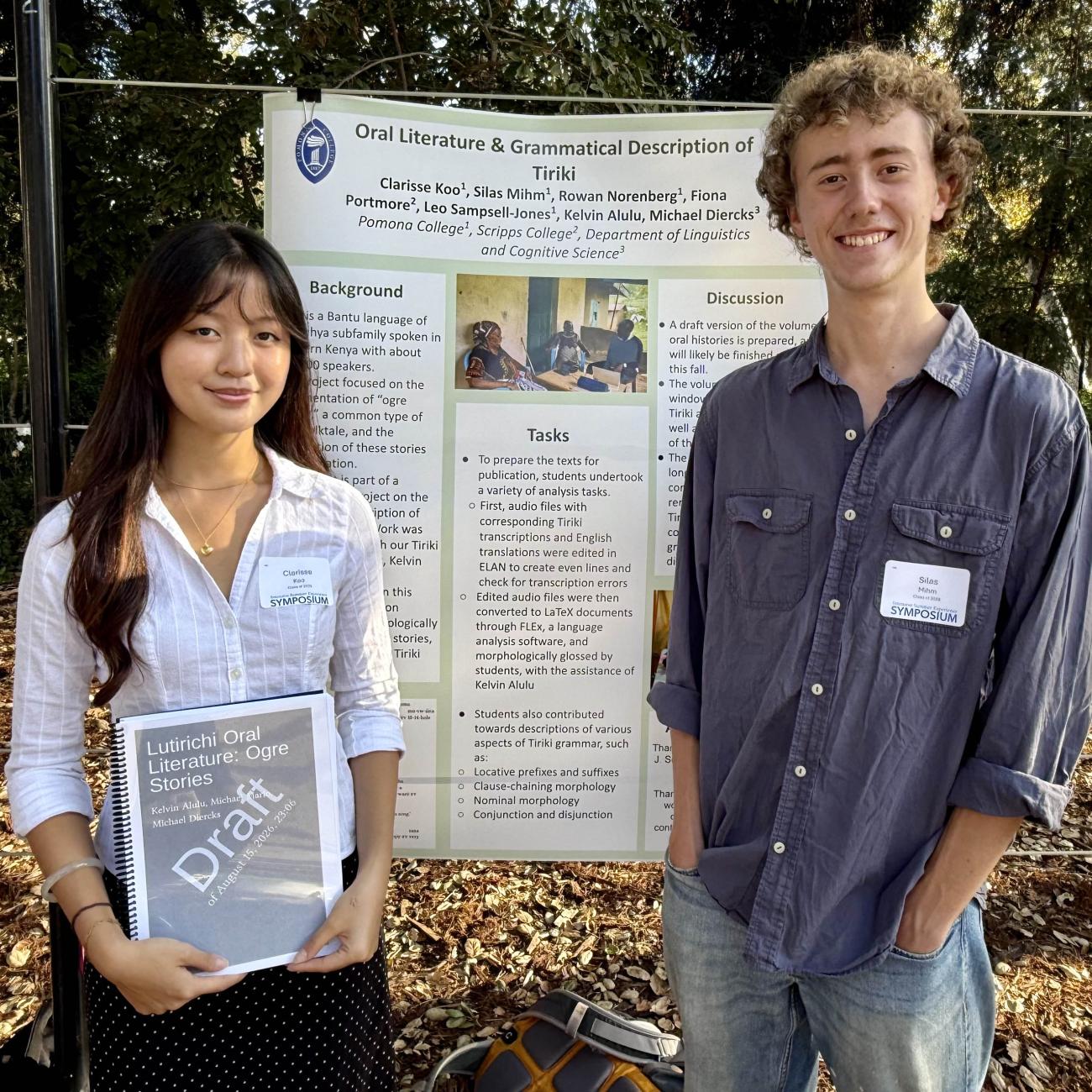 Two students stand by their SURP poster on Stover Walk.