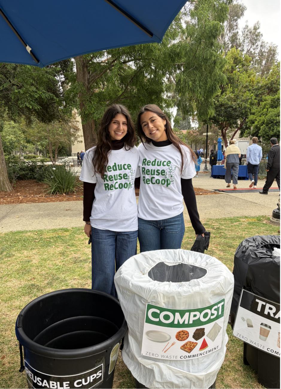 Two students stand near trash bins