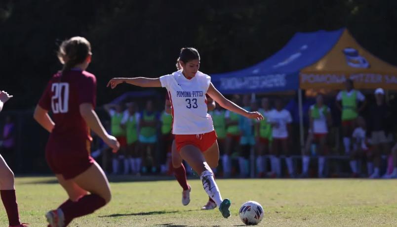 A soccer player kicks the ball