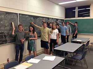 students in front of a chalkboard