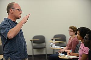 faculty member and students in biology classroom