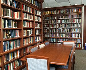 books in a library, with a table and chairs