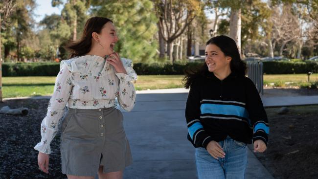Pomona College students take a stroll through campus in the fall.