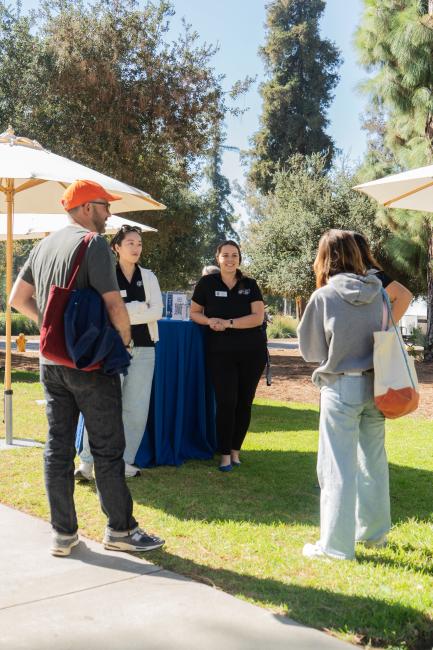 Four people standing around a table