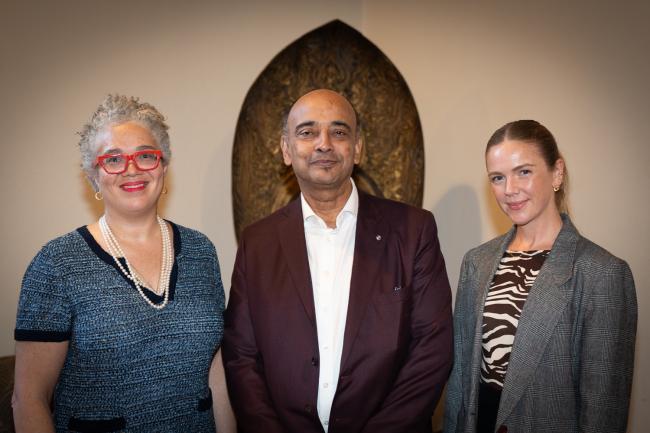 Three people stand for a picture