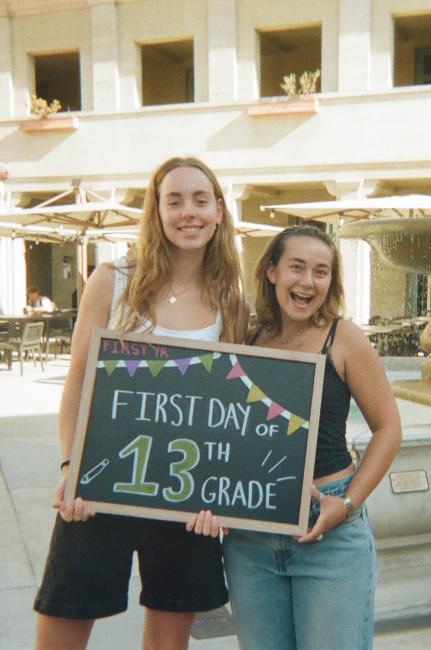 Two students hold a sign