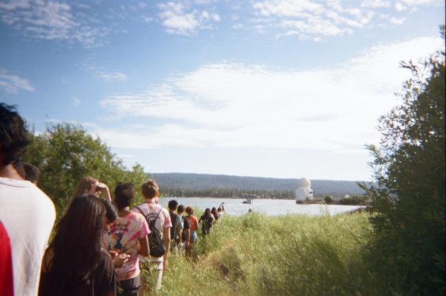 Students walk to a lake