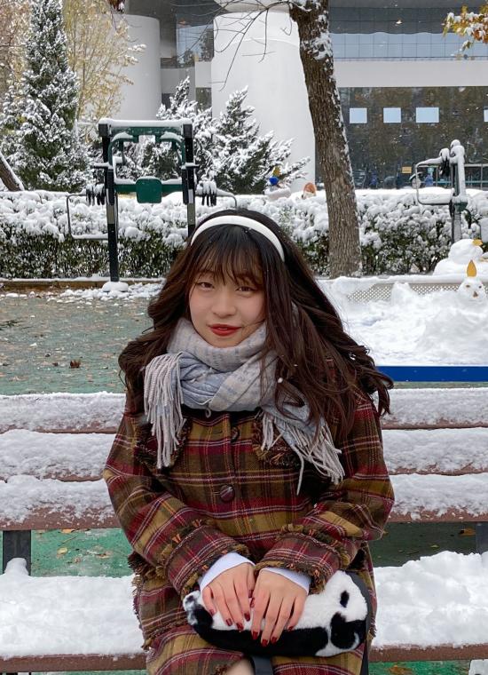 Chinese Language Resident sitting on a bench