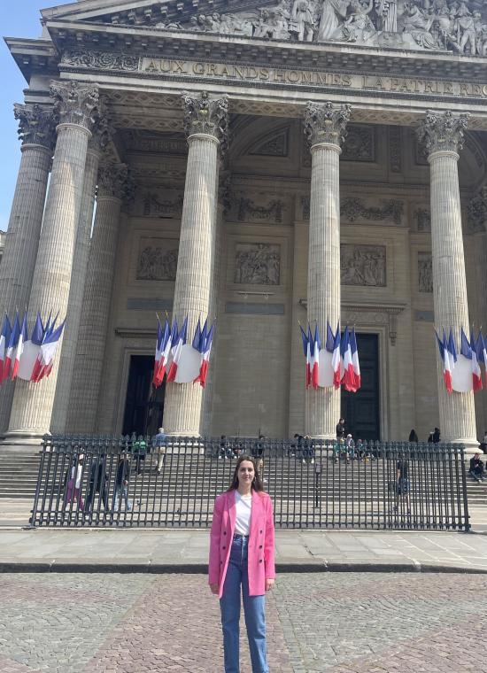 French Language Resident standing in front of a building